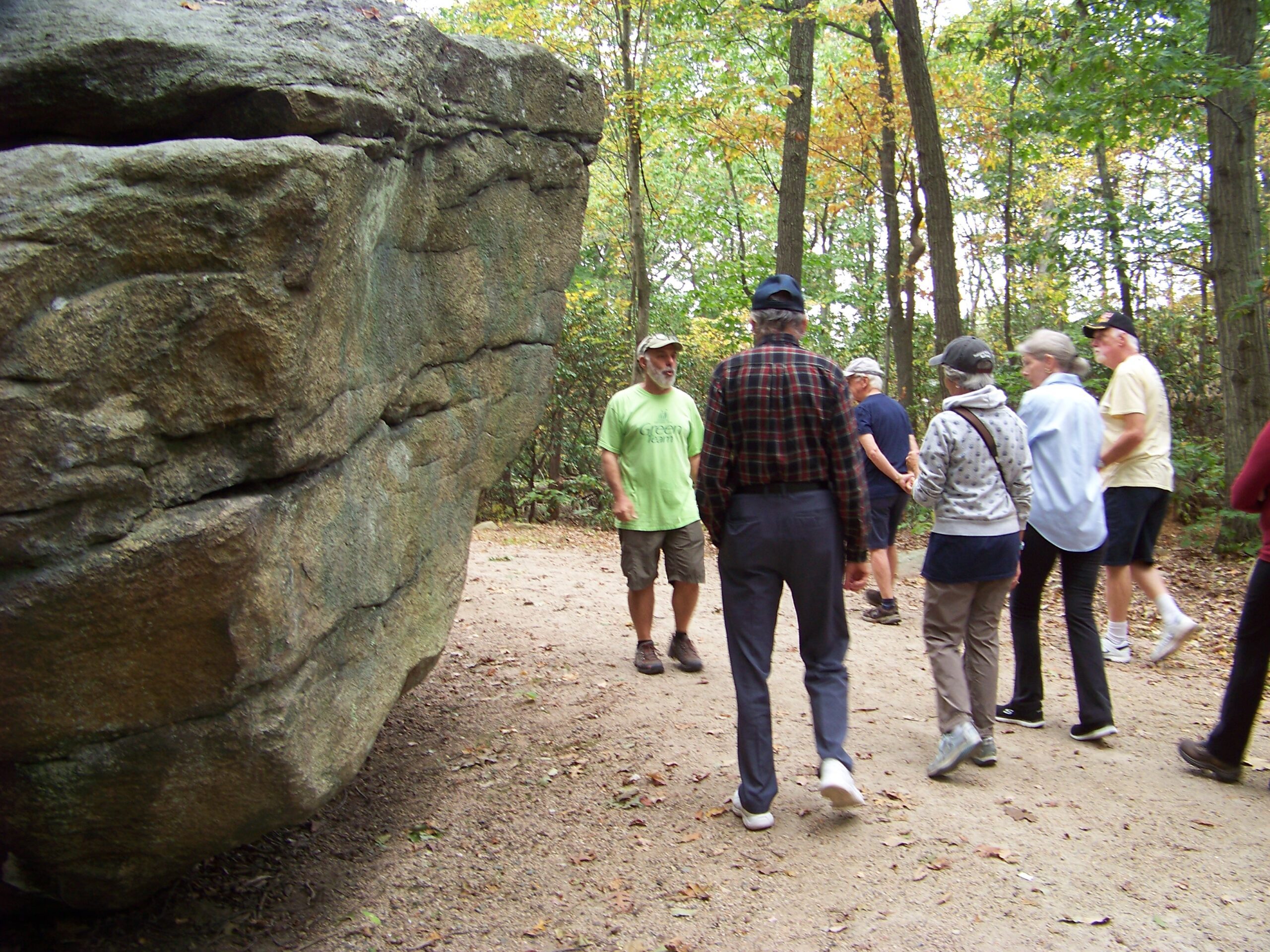 Interpretive trail guide Mike G. leads group past glacial rock